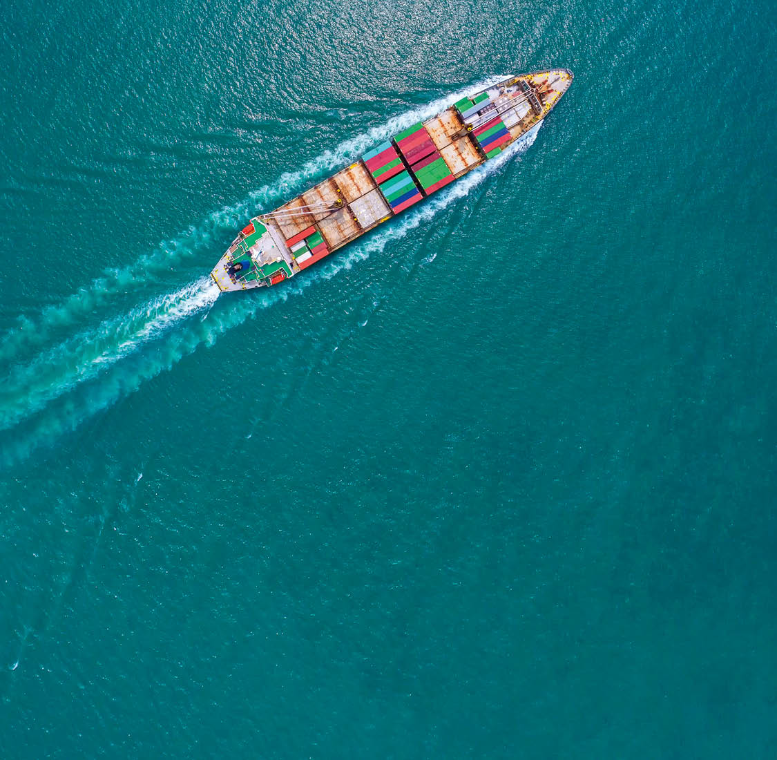 Container ship in export and import business and logistics  Shipping cargo to harbor by crane  Water transport International  Aerial view