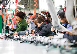 JIUJIANG CHINA-March 17, 2018: workers on the production line of electrical appliances company, Jiujiang, Eastern China  Workers can't relax for a minute, like robots in Chaplin's movie modern times 