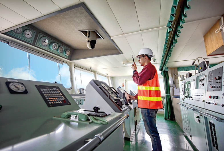 duty officer in charge handle of the ship navigating to the port destination, navigation on the bridge of the ship vessel under voyage sailing to the sea