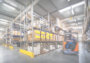 warehouse interior wit blurred forklift and worker in logistic center