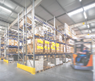 warehouse interior wit blurred forklift and worker in logistic center