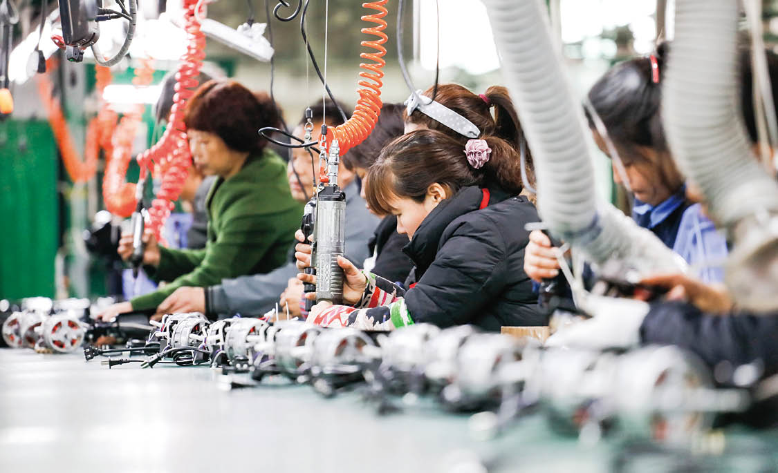 JIUJIANG CHINA-March 17, 2018: workers on the production line of electrical appliances company, Jiujiang, Eastern China  Workers can't relax for a minute, like robots in Chaplin's movie modern times 