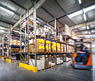 warehouse interior wit blurred forklift and worker in logistic center