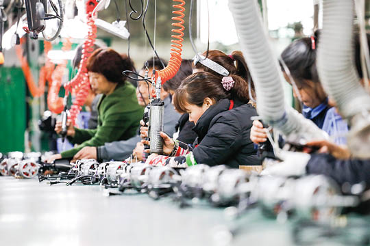 JIUJIANG CHINA-March 17, 2018: workers on the production line of electrical appliances company, Jiujiang, Eastern China  Workers can't relax for a minute, like robots in Chaplin's movie modern times 